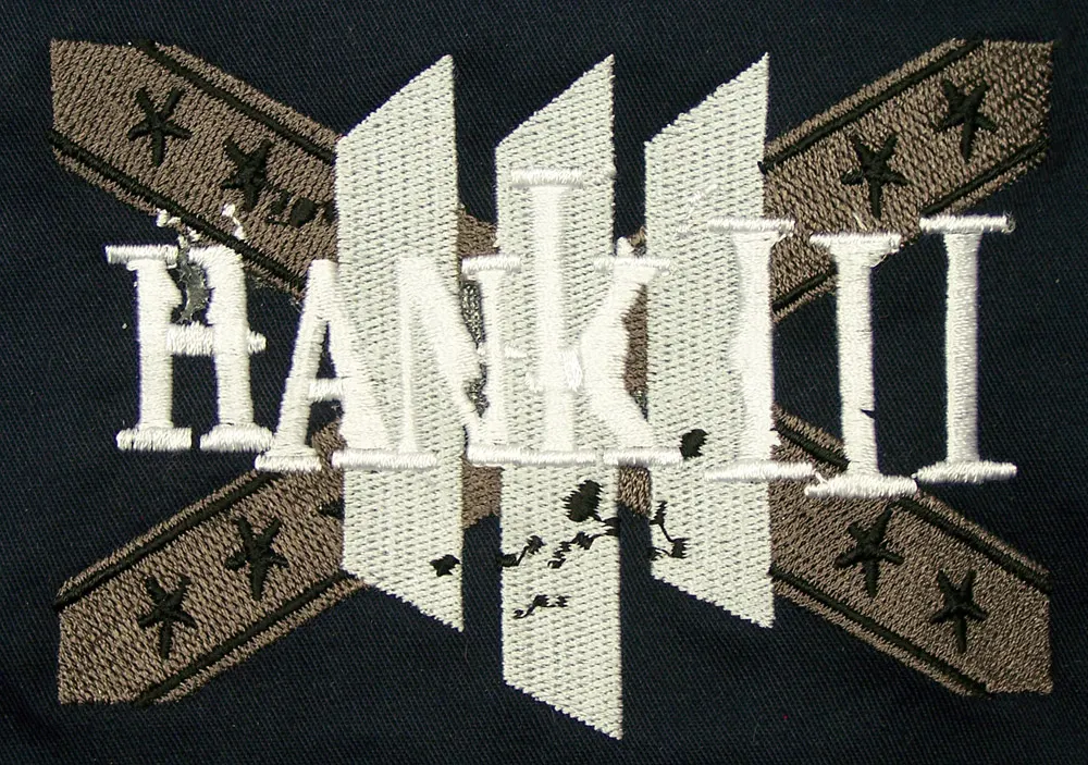 Embroidered Hank III artwork on black fabric